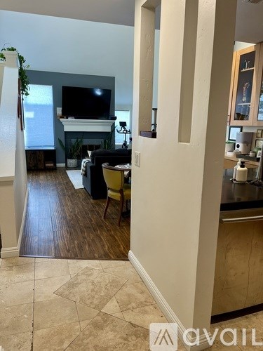 A living room with a couch and a television.