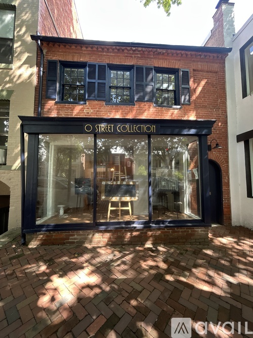 A brick building with a black awning that says Street Collection.