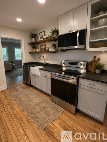 A kitchen with a black countertop and white cabinets.