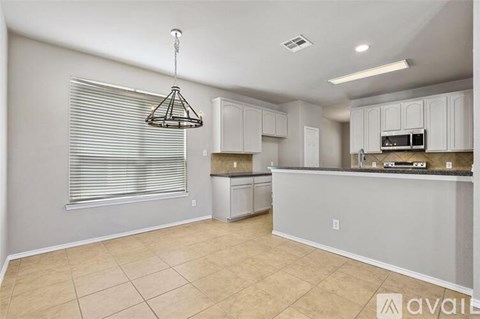 A kitchen with white cabinets and a countertop.