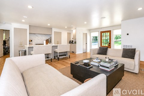 A modern living room with a white sofa and a black coffee table.