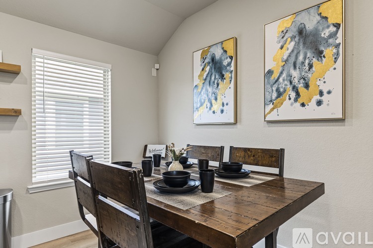 A dining room with a wooden table and chairs.