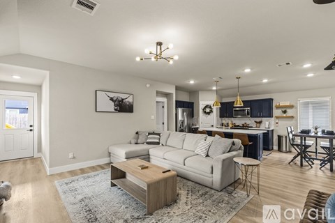 A living room with a grey couch and a coffee table.