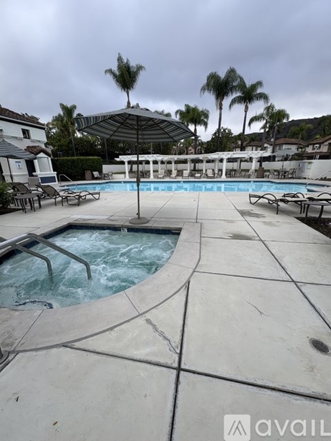 A pool with a hot tub in the middle of it.