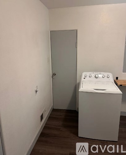 A bathroom with a sink and a door.