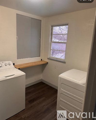 A small, clean, and well-lit laundry room with a washer and dryer.