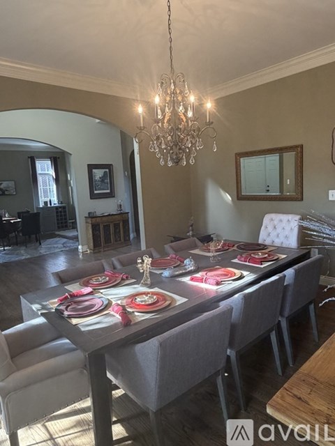 A dining room with a long table set for a meal.