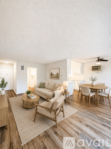 A living room with a couch, chairs, and a coffee table.