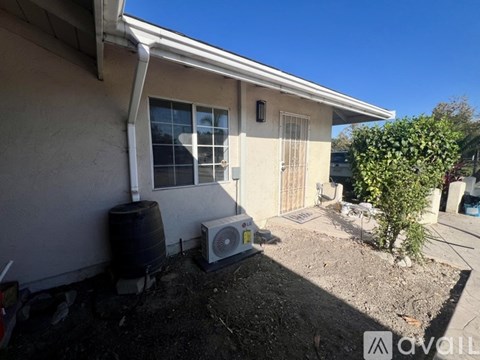A house with a wall-mounted air conditioner unit.