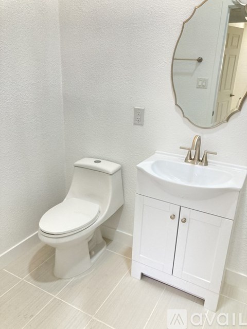 A white toilet and sink in a bathroom.