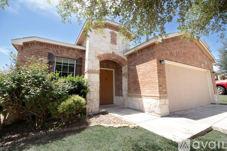 A house with a brown door and a white garage door.