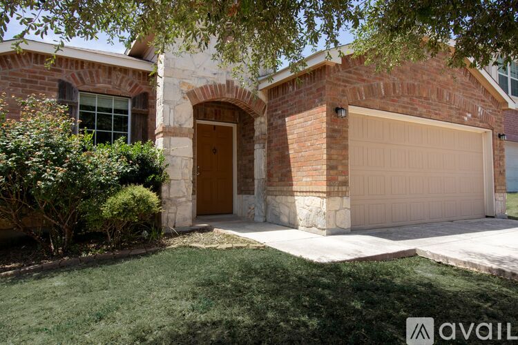 A house with a brown door and a garage door.