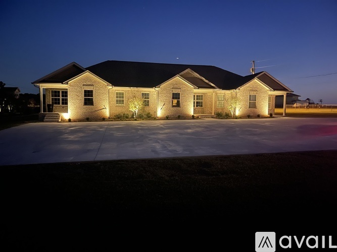 A house with lights on and a logo that says "AVAIL" on the bottom right.