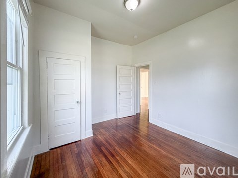 A room with wooden floors and white walls.