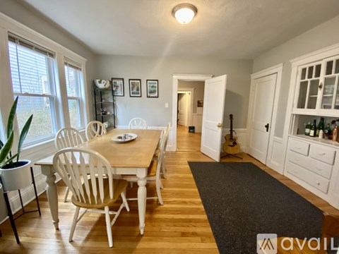A dining room with a table and chairs.