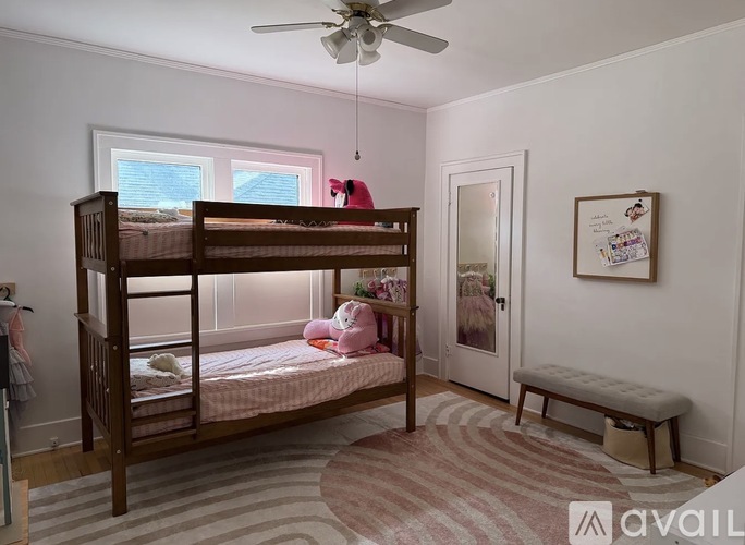 A bedroom with a bunk bed and a bench.