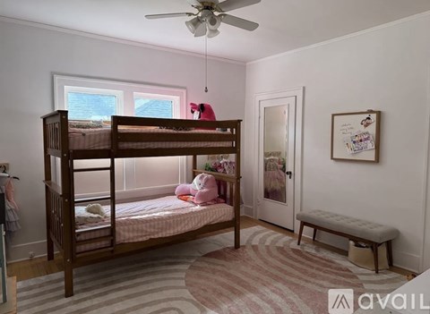 A bedroom with a bunk bed and a bench.