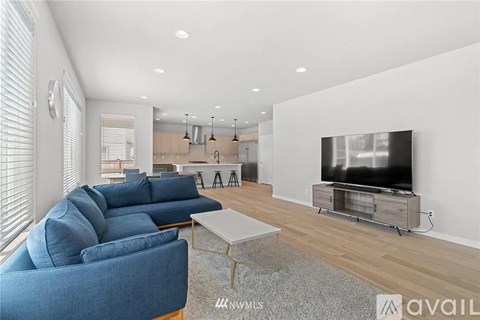 A modern living room with a blue sofa and a television.