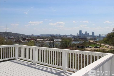 A balcony with a view of a city skyline.
