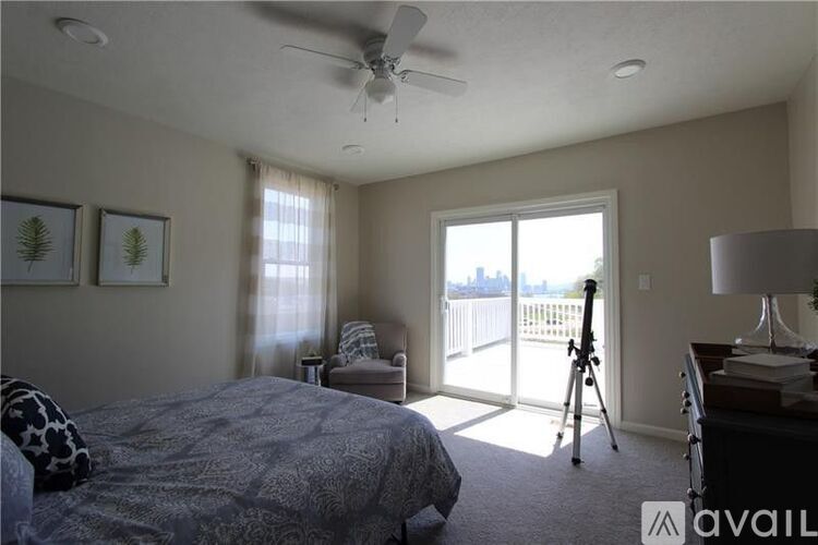 A bedroom with a bed, desk, and chair.