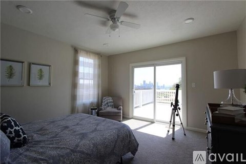 A bedroom with a bed, desk, and chair.