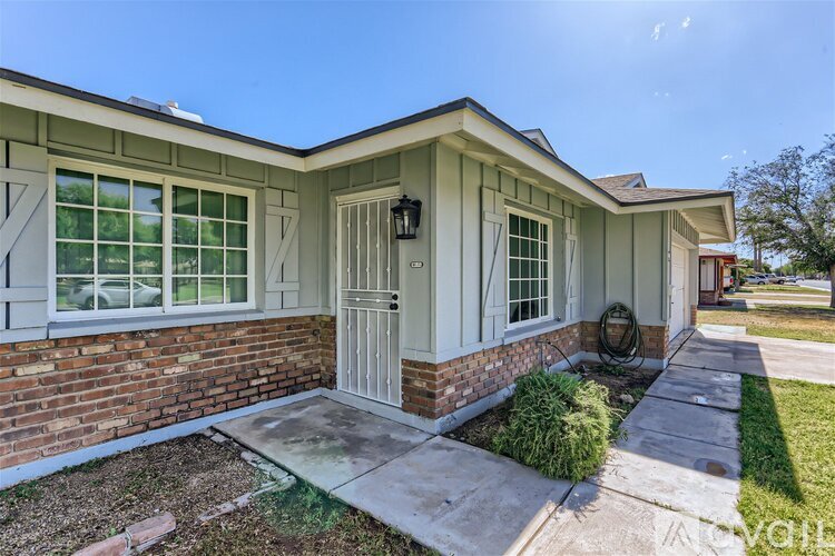 A house with a white door and windows is for sale.