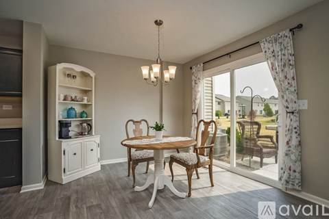 A dining room with a wooden table and chairs.