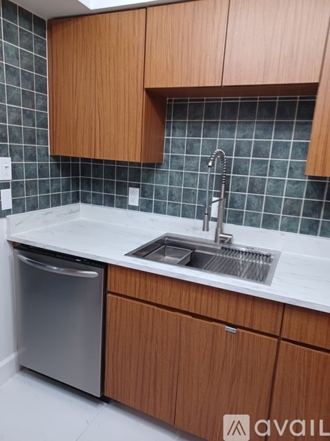A kitchen with wooden cabinets and a white countertop.