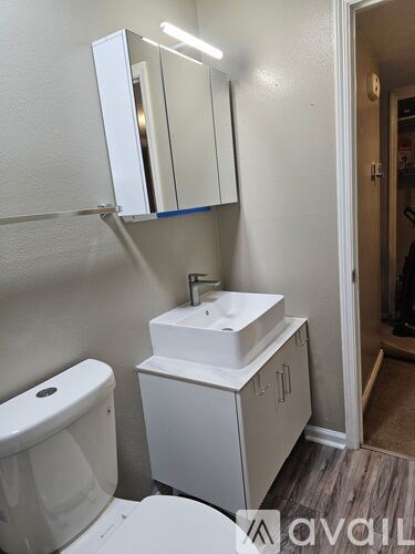 A white toilet and sink in a small bathroom.