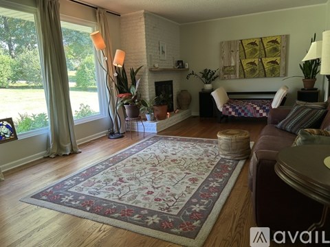 A living room with a rug on the floor and a couch.