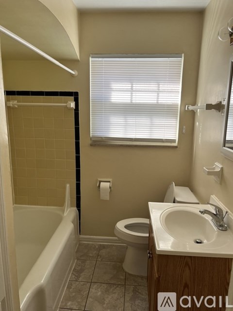 A bathroom with a toilet, sink, and bathtub.