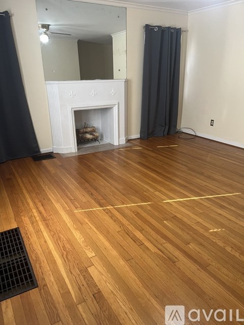 A room with a fireplace and wooden floors.