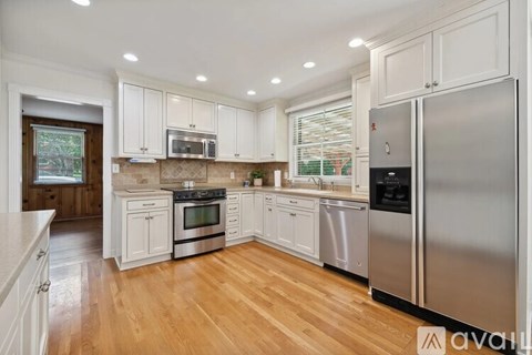 A kitchen with white cabinets and stainless steel appliances.