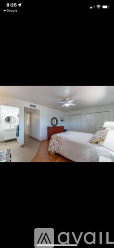 A bedroom with a bed, dresser, and mirror.