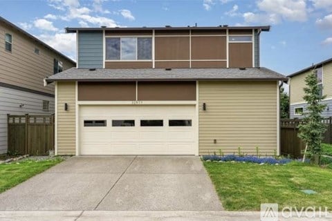 A two-car garage with a brown and beige exterior.