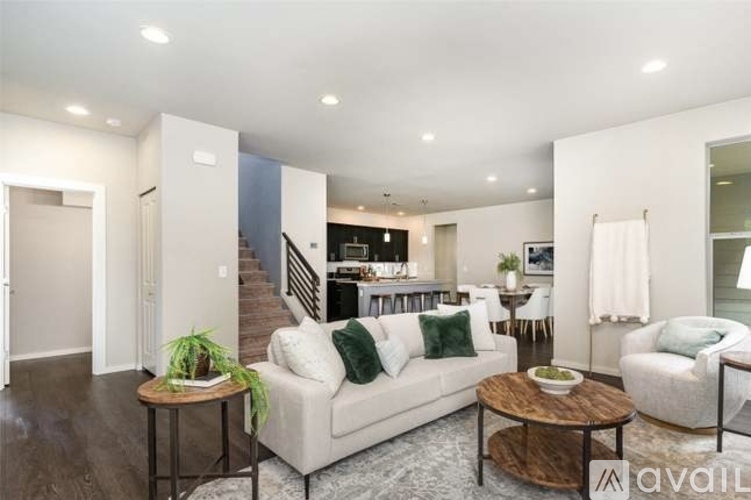 A living room with a white couch and a coffee table.