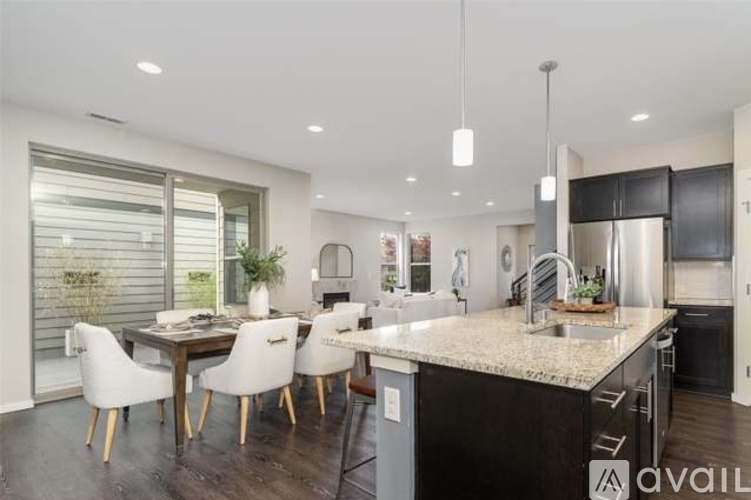A modern kitchen with a dining table and chairs.