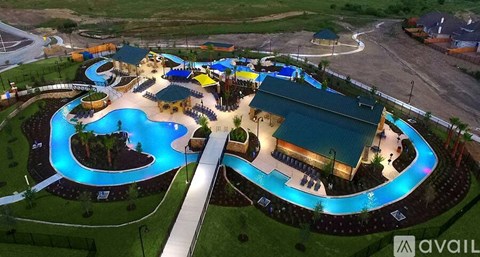 A large outdoor swimming pool with a slide and a building.