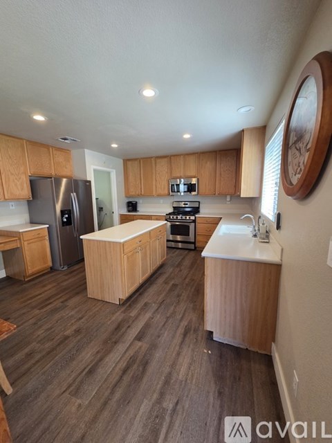 A kitchen with wooden cabinets and a refrigerator.