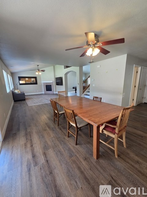 A dining room with a wooden table and chairs.