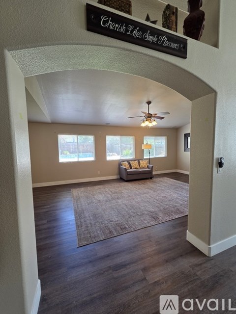 A living room with a couch and a sign that says "Cherish 2 lives simply please".