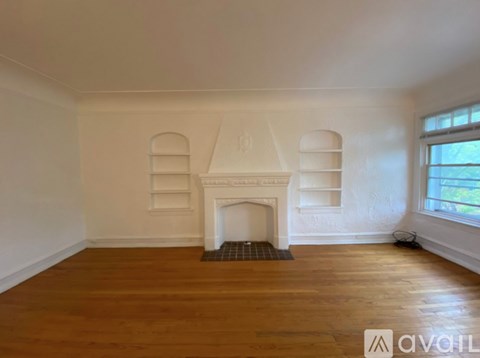 A room with a fireplace and wooden floors.
