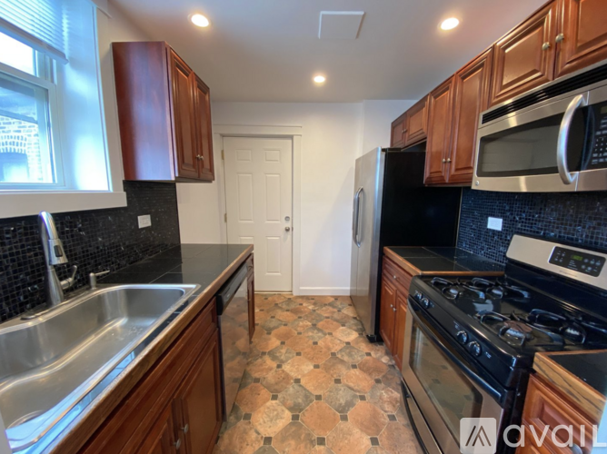 A kitchen with a black and white checkered floor.