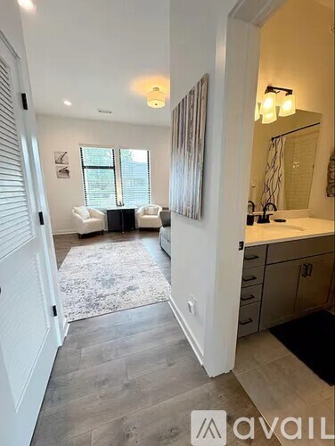 A well-lit, spacious room with a grey floor and white walls.