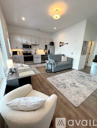 A modern kitchen with a dining area and a living room.