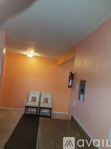 Two chairs are placed in a room with orange walls.