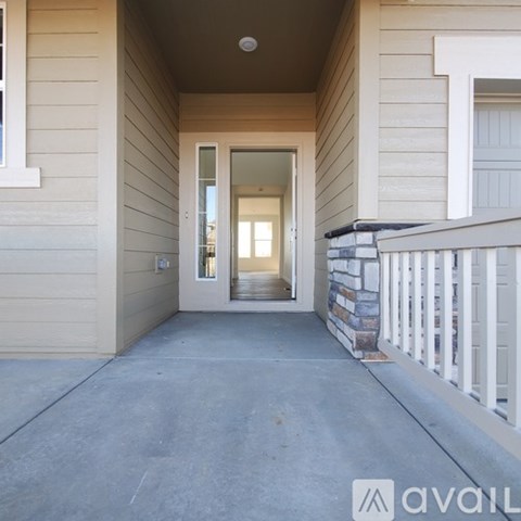 A house entrance with a glass door and a white railing.
