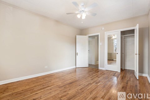 A room with wooden floors and a ceiling fan.