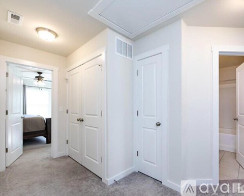 A bedroom with a bed and a window.