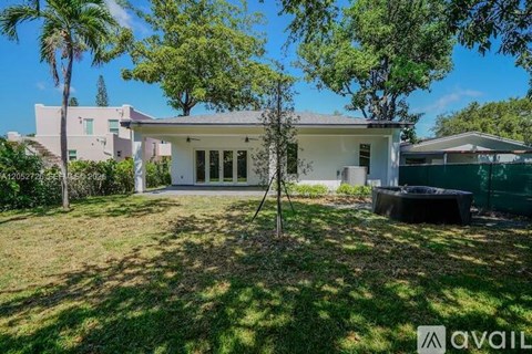 A house with a white exterior and a large front yard.
